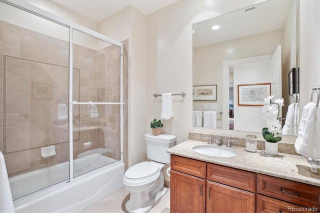 full bathroom featuring vanity, combined bath / shower with glass door, and toilet