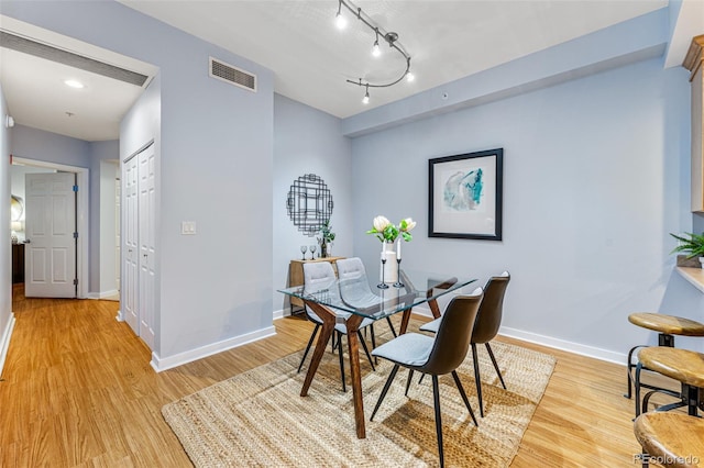 dining space featuring track lighting and light hardwood / wood-style floors