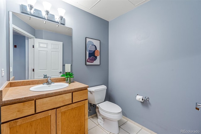 bathroom with tile patterned flooring, vanity, and toilet