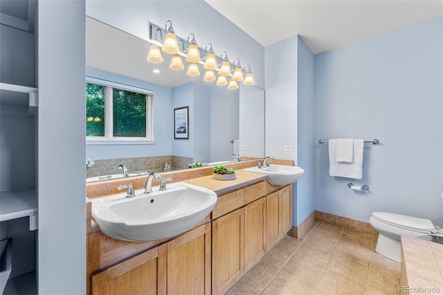 bathroom featuring vanity, tile patterned floors, and toilet