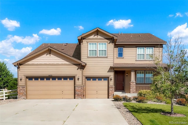 craftsman-style house with a front yard and a garage