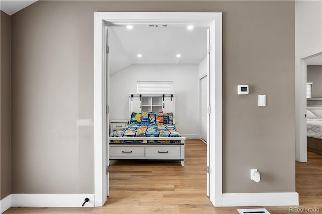 interior space featuring light hardwood / wood-style flooring and vaulted ceiling