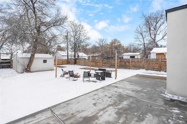 yard covered in snow featuring an outdoor structure