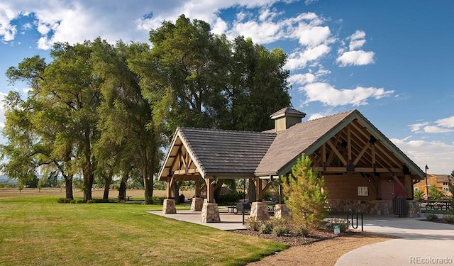 surrounding community with a gazebo and a lawn