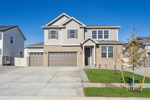 view of front of home with a garage and a front lawn