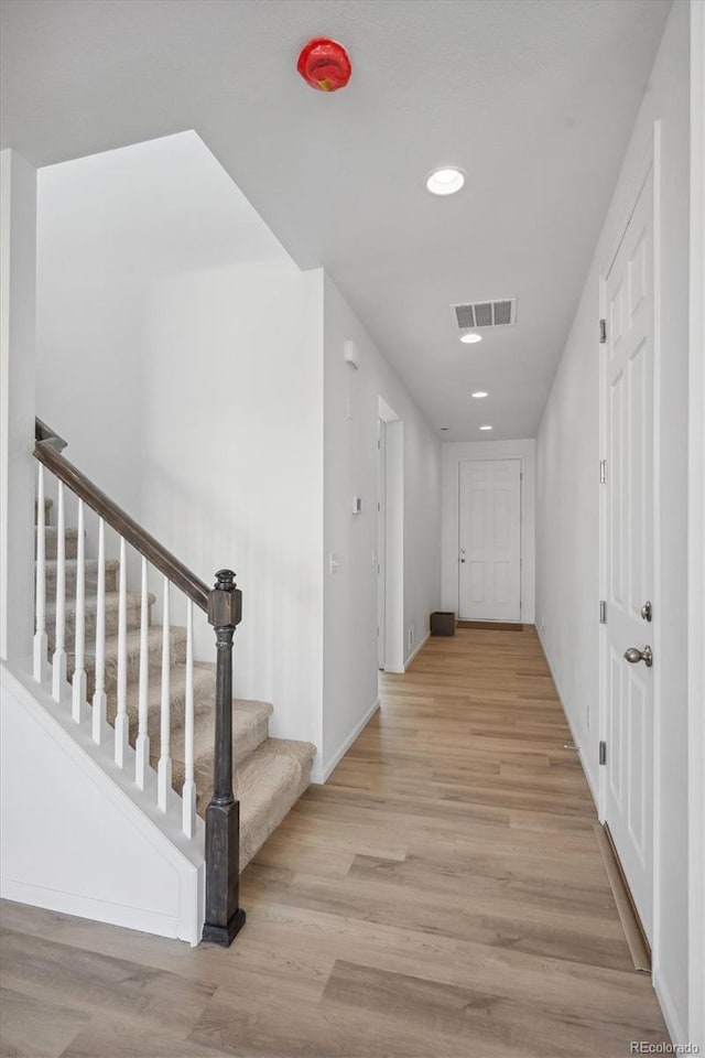 hall with light hardwood / wood-style floors