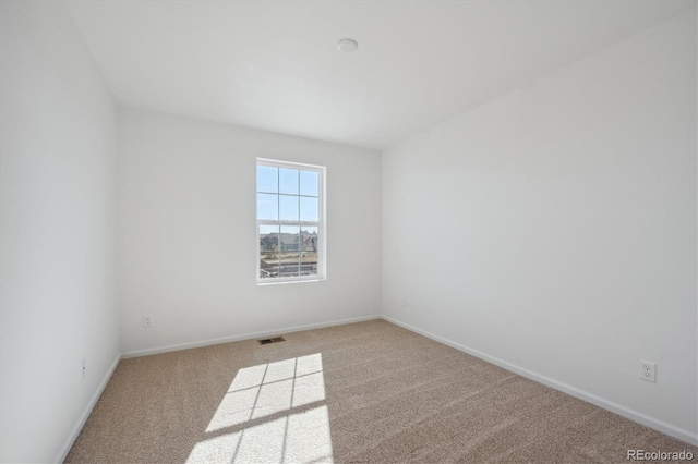 spare room with light carpet