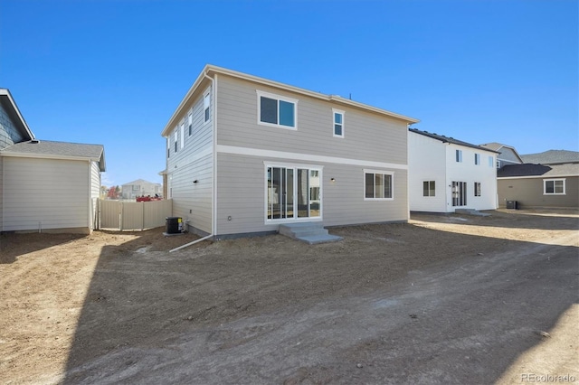 rear view of property with central AC