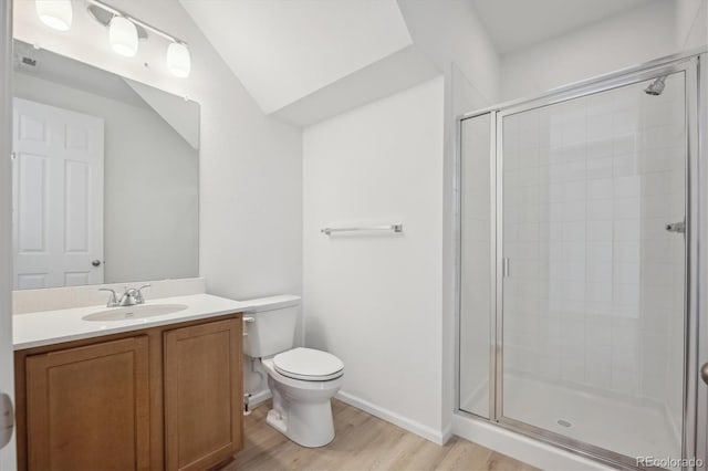 bathroom featuring a shower with door, toilet, vanity, and hardwood / wood-style floors