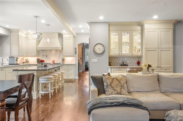 7836 S Fairfax Ct, Centennial, CO 80122 - living area featuring recessed lighting, arched walkways, and wood finished floors