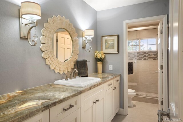 7836 S Fairfax Ct, Centennial, CO 80122 - bathroom with vanity, tile patterned floors, a tile shower, and toilet