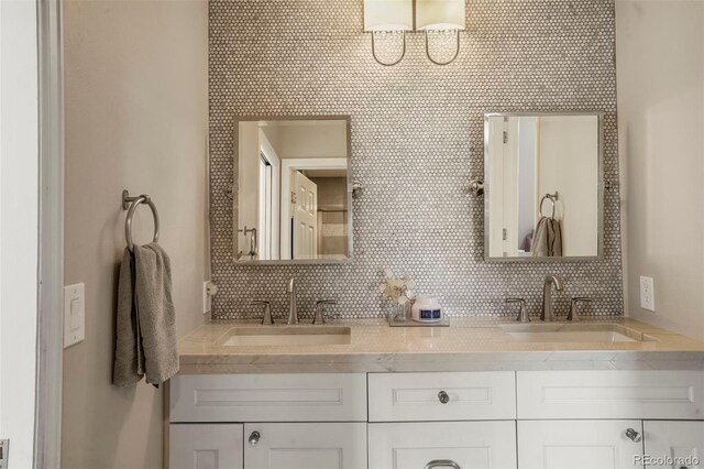 7836 S Fairfax Ct, Centennial, CO 80122 - full bathroom featuring double vanity, a sink, and backsplash