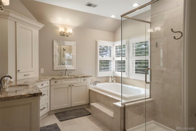 7836 S Fairfax Ct, Centennial, CO 80122 - bathroom with a garden tub, visible vents, a stall shower, a sink, and lofted ceiling