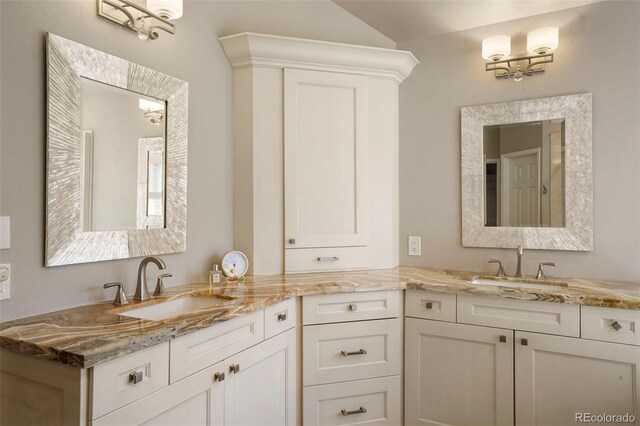7836 S Fairfax Ct, Centennial, CO 80122 - bathroom featuring double vanity, a sink, and vaulted ceiling