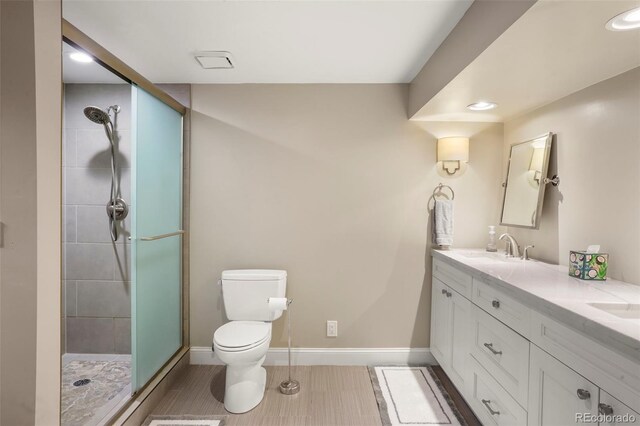 7836 S Fairfax Ct, Centennial, CO 80122 - full bathroom with double vanity, a tile shower, a sink, toilet, and recessed lighting