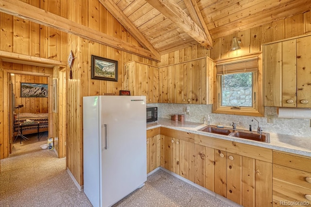 kitchen with white fridge, wood ceiling, backsplash, and sink