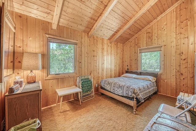 carpeted bedroom with wood walls, vaulted ceiling with beams, and wooden ceiling