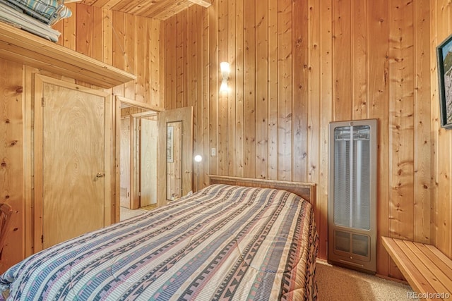 bedroom featuring wood walls, a high ceiling, and carpet flooring