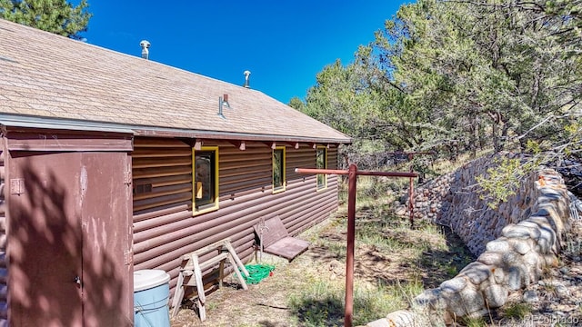 view of home's exterior featuring a storage unit