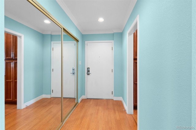 hall with light wood-type flooring and ornamental molding