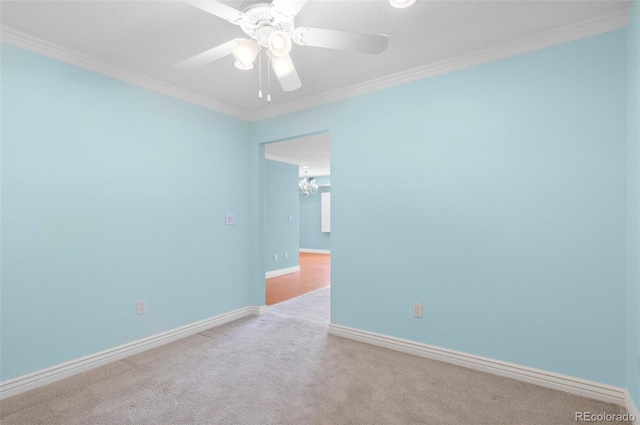 carpeted spare room featuring crown molding and ceiling fan with notable chandelier