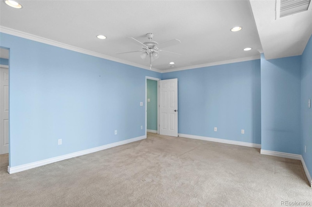 spare room featuring ceiling fan, crown molding, and light colored carpet