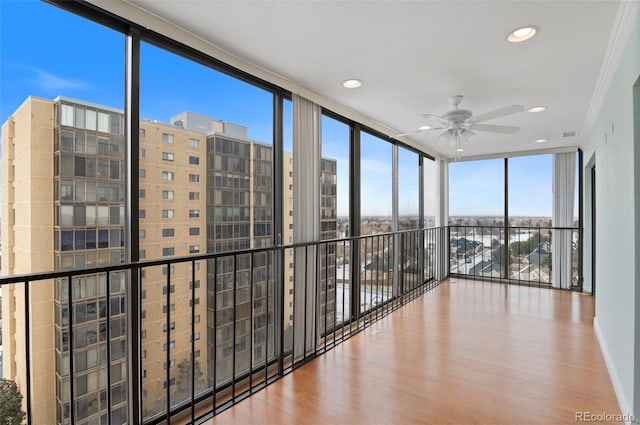 unfurnished sunroom with ceiling fan