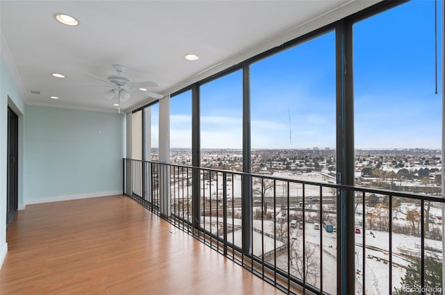 unfurnished sunroom featuring ceiling fan