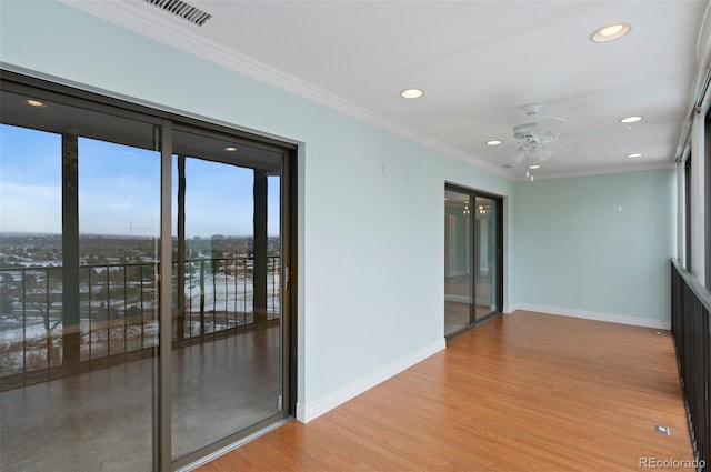 unfurnished room featuring ceiling fan, crown molding, and light hardwood / wood-style floors