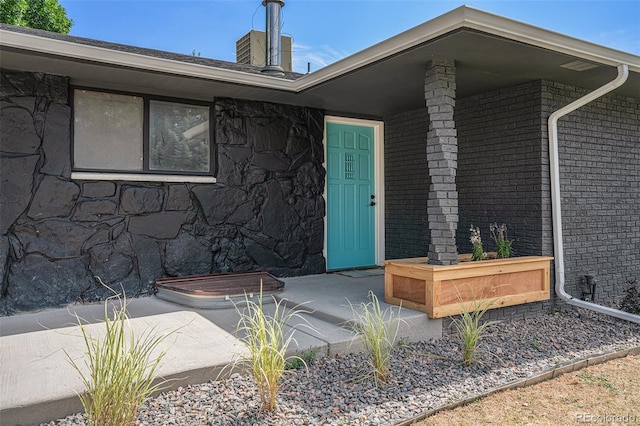 doorway to property with brick siding