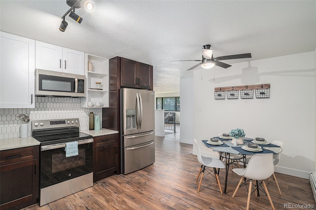 kitchen featuring light countertops, appliances with stainless steel finishes, backsplash, and dark brown cabinets