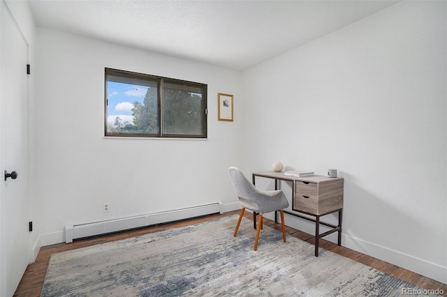 office with baseboard heating, wood finished floors, and baseboards