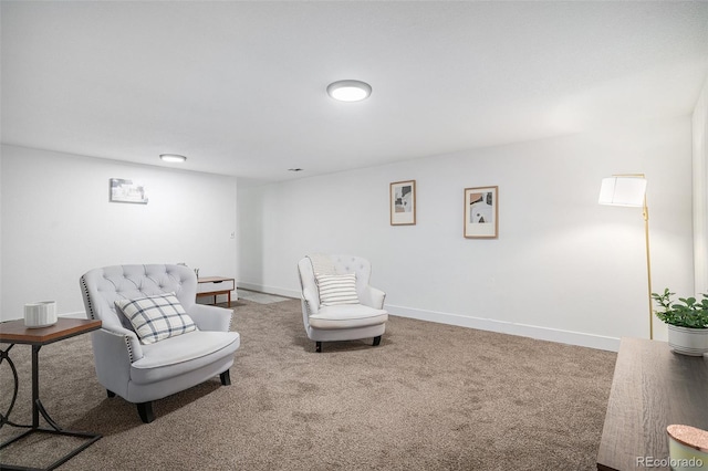 sitting room featuring carpet and baseboards