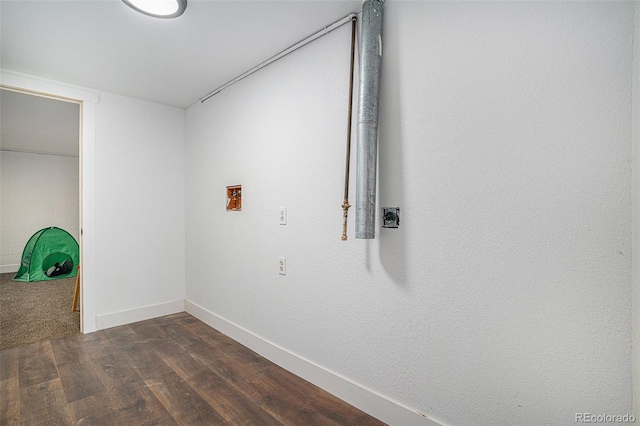 spare room with dark wood-style flooring and baseboards