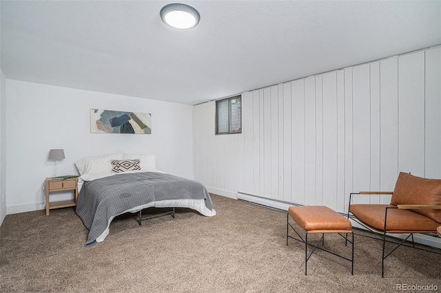 carpeted bedroom featuring baseboard heating and a textured ceiling