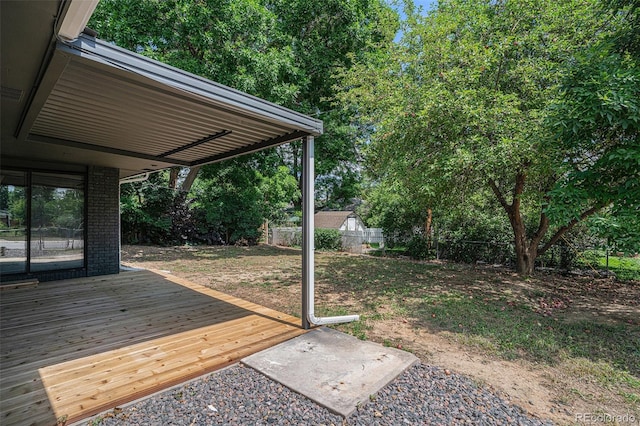 view of yard with a fenced backyard and a wooden deck