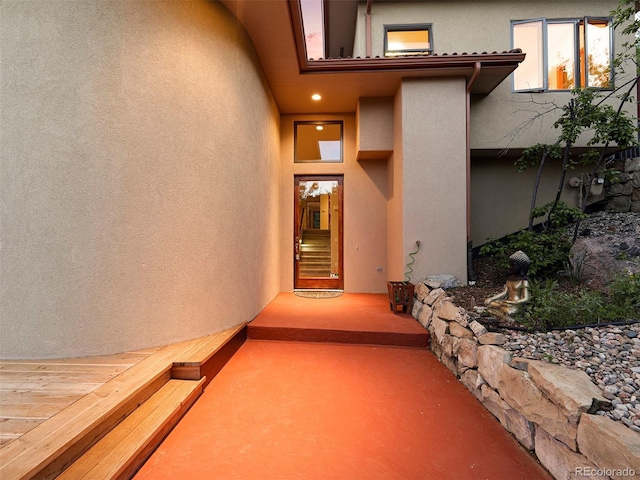 property entrance featuring stucco siding