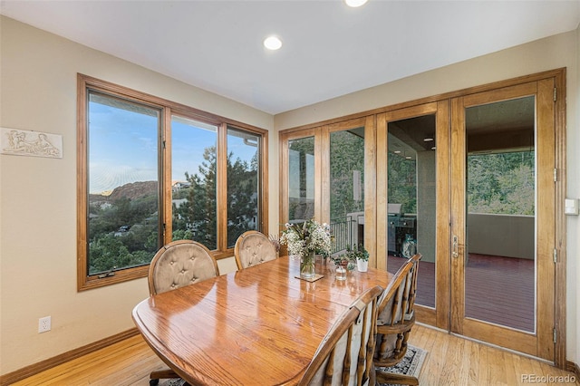 dining space with light wood-style floors, baseboards, and recessed lighting