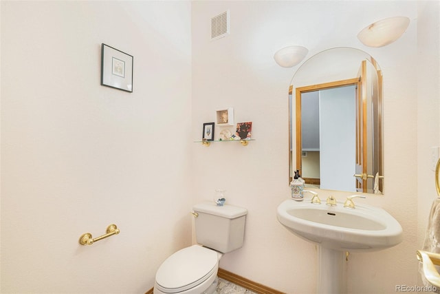 half bathroom with toilet and visible vents