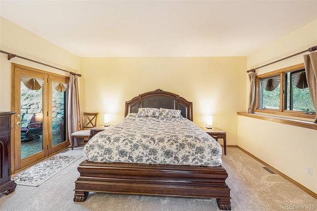 bedroom featuring light colored carpet, visible vents, baseboards, and access to exterior