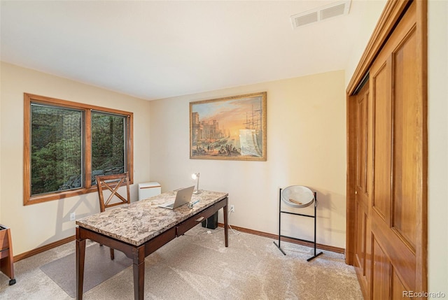 office area with baseboards, visible vents, and light colored carpet