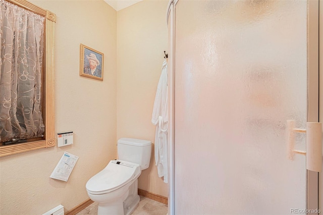 bathroom featuring toilet and baseboards