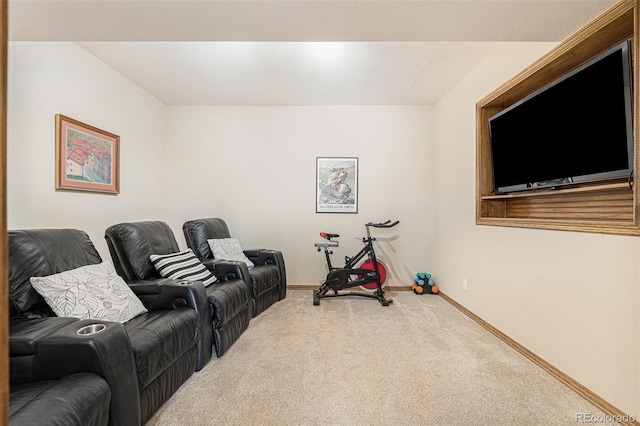 carpeted home theater featuring baseboards