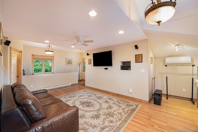 living area with a ceiling fan, a wall mounted air conditioner, recessed lighting, a baseboard heating unit, and light wood-style floors