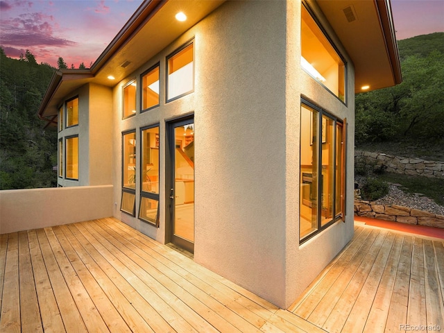 wooden deck featuring visible vents