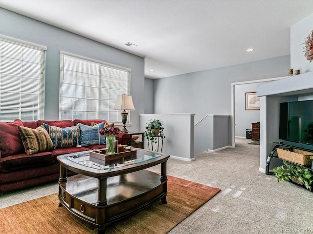 carpeted living room with a healthy amount of sunlight