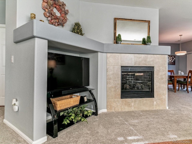 living room with carpet and a tile fireplace