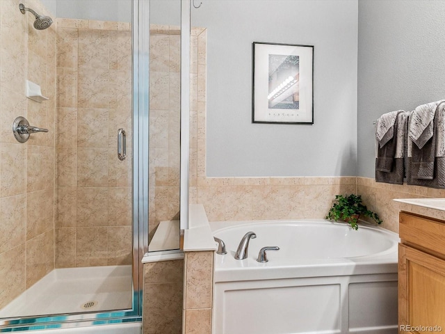 bathroom featuring separate shower and tub and vanity