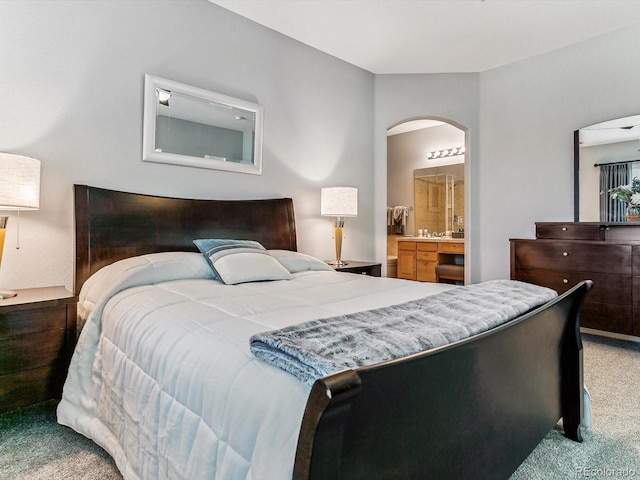 carpeted bedroom featuring connected bathroom