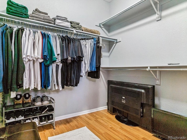 spacious closet featuring wood-type flooring and heating unit